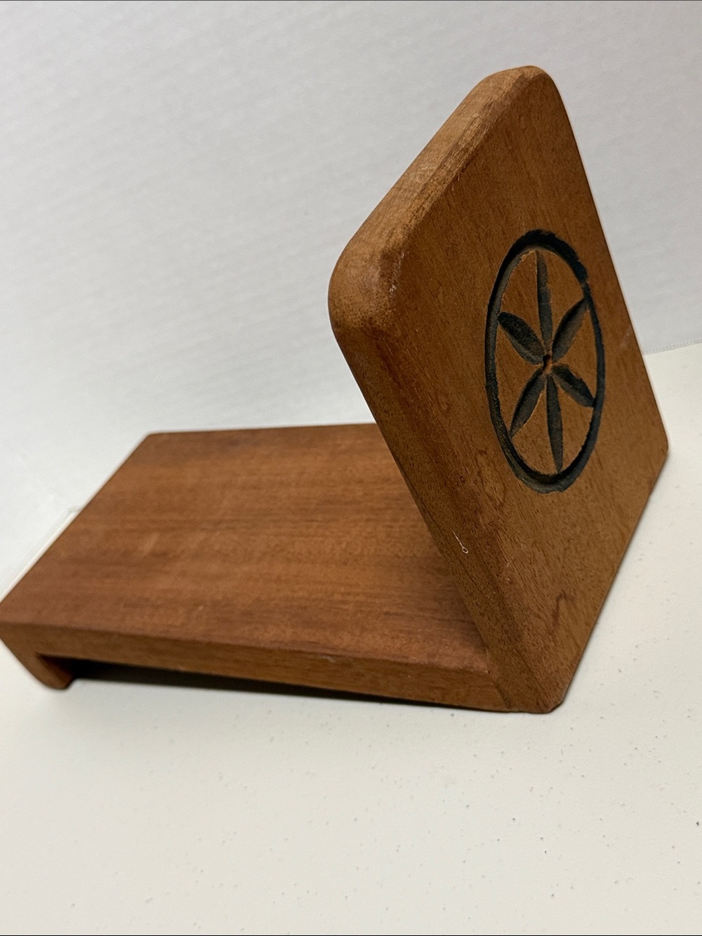 Hand crafted mid-century solid wood slanted gravity book rack with carved flower